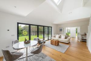 a living room with a table and chairs at Beautiful countryside home, 10min drive to Bath in Limpley Stoke