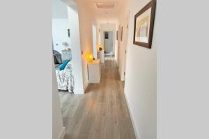 a hallway with white walls and wooden floors at Camden House luxury home near Ben Nevis Scotland Highlands in Fort William