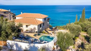 an aerial view of a villa with a swimming pool and the ocean at Xigia Escape villas in Khartáta