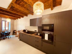 a kitchen with stainless steel appliances and a dining room at Appartement confortable et moderne in La Roche-sur-Foron