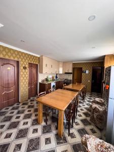 a kitchen with a large wooden table and chairs at Giorgi's Guest House in Kazbegi