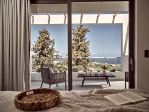 a bedroom with a bed and a view of a patio at Julieta Villas in Zakynthos