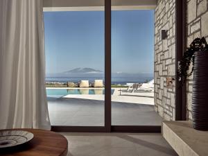 a living room with a view of a swimming pool at Julieta Villas in Zakynthos