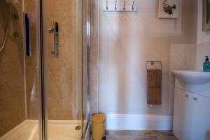 a shower with a glass door in a bathroom at The Ryedale in Shanklin