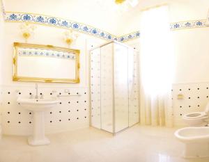 a bathroom with a sink and a toilet at Le scuderie di Villa Ravenna Luxury House in Sannicola +17 photos