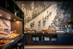 a restaurant with a large picture of a crowd of people at Hotel Hulsman in Valkenburg