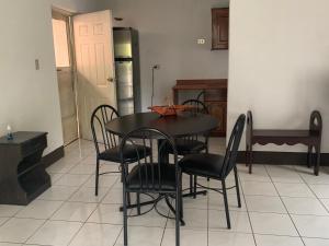 comedor con mesa, sillas y nevera en Casa a 5 minutos de los parques del IRTRA en Pucá