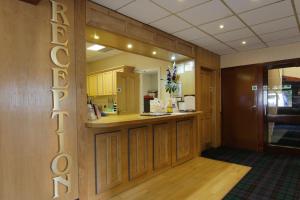 a large kitchen with a large mirror on the wall at Craigmonie Hotel Inverness by Compass Hospitality in Inverness