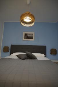 a bedroom with a large bed with a blue wall at Giata home in Naples