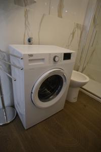 a washing machine in a bathroom with a toilet at Giata home in Naples +9 photos