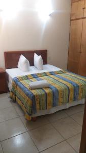 a bed with two pillows on it in a room at Hotel Quinta Loriffe in Cuautla Morelos