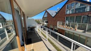 a balcony with a view of a building at Apartament Mechelinki, wysoki standard. in Pierwoszyno