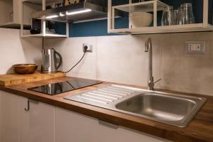 A kitchen or kitchenette at Rione Monti Studio Apt with private garden