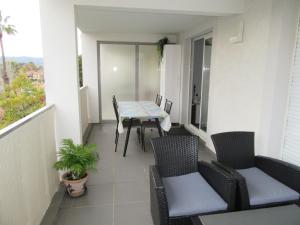 a balcony with a table and chairs on it at appartement résidence La Plage 4 **** in La Londe-les-Maures