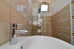 a bathroom with a sink and a faucet at Boomerang Residence a Torre Colimena in Torre Colimena