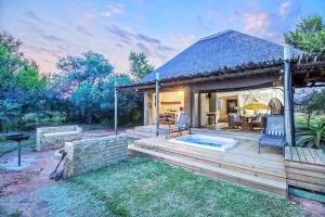 a house with a deck with a swimming pool at LookOut Safari Lodge in Klipdrift