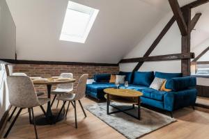 a living room with a blue couch and a table at DreamHouse7 in Zagreb