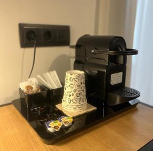 a coffee maker and a cup on a counter at Blanq Comedias in Valencia