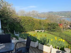 a patio with a table and chairs and a garden at Superb Garden Suite at The Moorings Shaldon in Shaldon