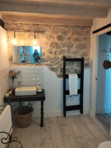 a bathroom with a sink and a mirror at La buganvilla en Udías in Udias