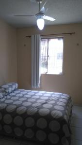 a bedroom with a large bed and a window at Apartamento Caucaia-CE, próximo á praia de Cumbuco in Fortaleza