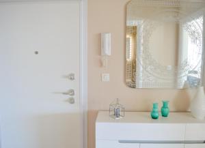a bathroom with a mirror and a white dresser at Rova Apartment in Malinska +19 photos