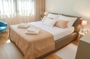 a bedroom with a bed with two towels on it at Rova Apartment in Malinska
