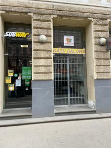 a store front with a window with a sign on it at Orange Cat Rooms in Riga