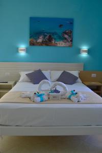 a bed with towels and swans on it at Le Twins -Bed and Breakfast in Tropea
