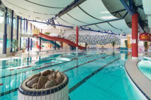 a large swimming pool with a large swimming pool at Casita - Sterneferienhaus mit Garten, Sauna und Wallbox in Kirburg