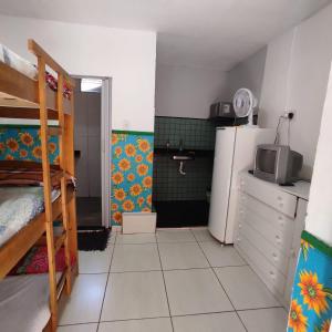 uma pequena cozinha com frigorífico e micro-ondas em Hostel Trem Di Durmi em Belo Horizonte