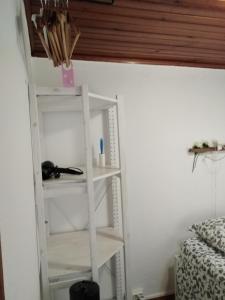 a white shelf in a room with a bed at Alfama with a view in Lisbon