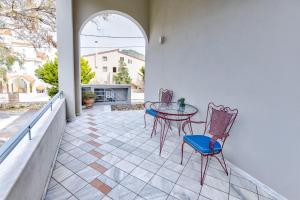 a patio with two chairs and a table on a balcony at Monemvasia Modern flat in Monemvasia