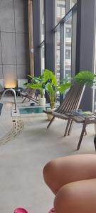 a group of benches in a building with plants at Mountain Eyes Titova vila in Palisad