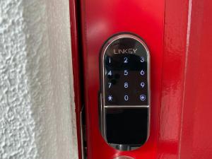 a close up of a remote control on a red door at Royal Heights Chuocho - Vacation STAY 12747 in Kagoshima