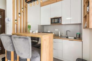 a small kitchen with a wooden table and chairs at Mountain Eyes Titova vila in Palisad