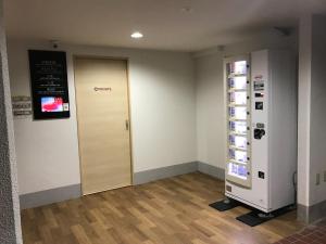 a room with a door with a sign on the wall at Royal Heights Chuocho - Vacation STAY 12765 in Kagoshima