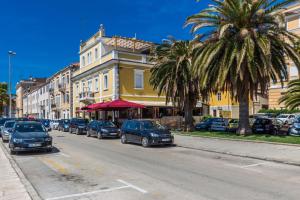 a street with cars parked on the side of the road at B&B Giardin exclusive rooms and suite in Zadar