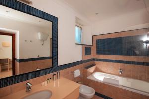 a bathroom with a tub and a sink and a toilet at Hotel Villa Ceselle in Anacapri +37 photos