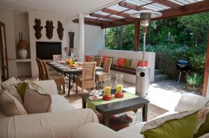 a living room with a table with glasses on it at Fernwood Manor Boutique Guest House in Cape Town