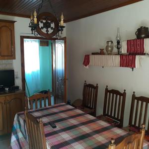 a dining room with a table and a window at Rooms for Rent in Shkodër