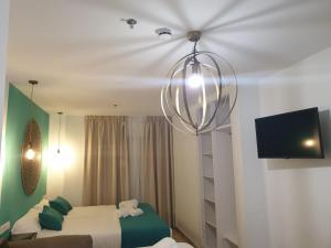 Ліжко або ліжка в номері Apartamentos Doña Lola