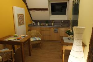 a kitchen with a table and a dining room at Studio in der alten Scheune in Eschbach