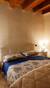 a bed with two pillows on it in a bedroom at Ca' degli Sposi in Mantova