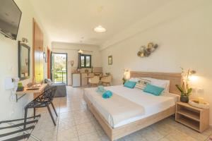 a bedroom with a large bed and a living room at Yianetta Hotel Apartments in Kavos