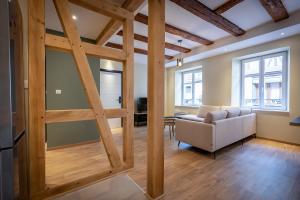 a living room with a wooden door and a couch at SERENITY Colmar - Gîtes de Prestige 4 et 5 étoiles - 2, 4 et 6 personnes- Centre Historique in Colmar