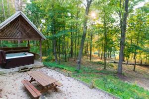 a picnic table and a gazebo in a forest at Cherry Ridge Retreat Luxury Cabins 