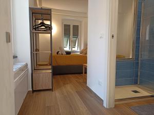 a room with a mirror and a bedroom with a bed at Al Porto 61 - Rooms for Rent in Camogli