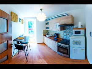 uma cozinha com uma mesa e um fogão forno superior em Apartment Pod Sychrovem em Praga