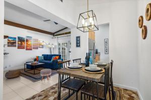 a dining room and living room with a table and chairs at CocoBay 2BR Condos Near Beach, Galleria Mall, Wilton Manors, Cruise Port in Fort Lauderdale
